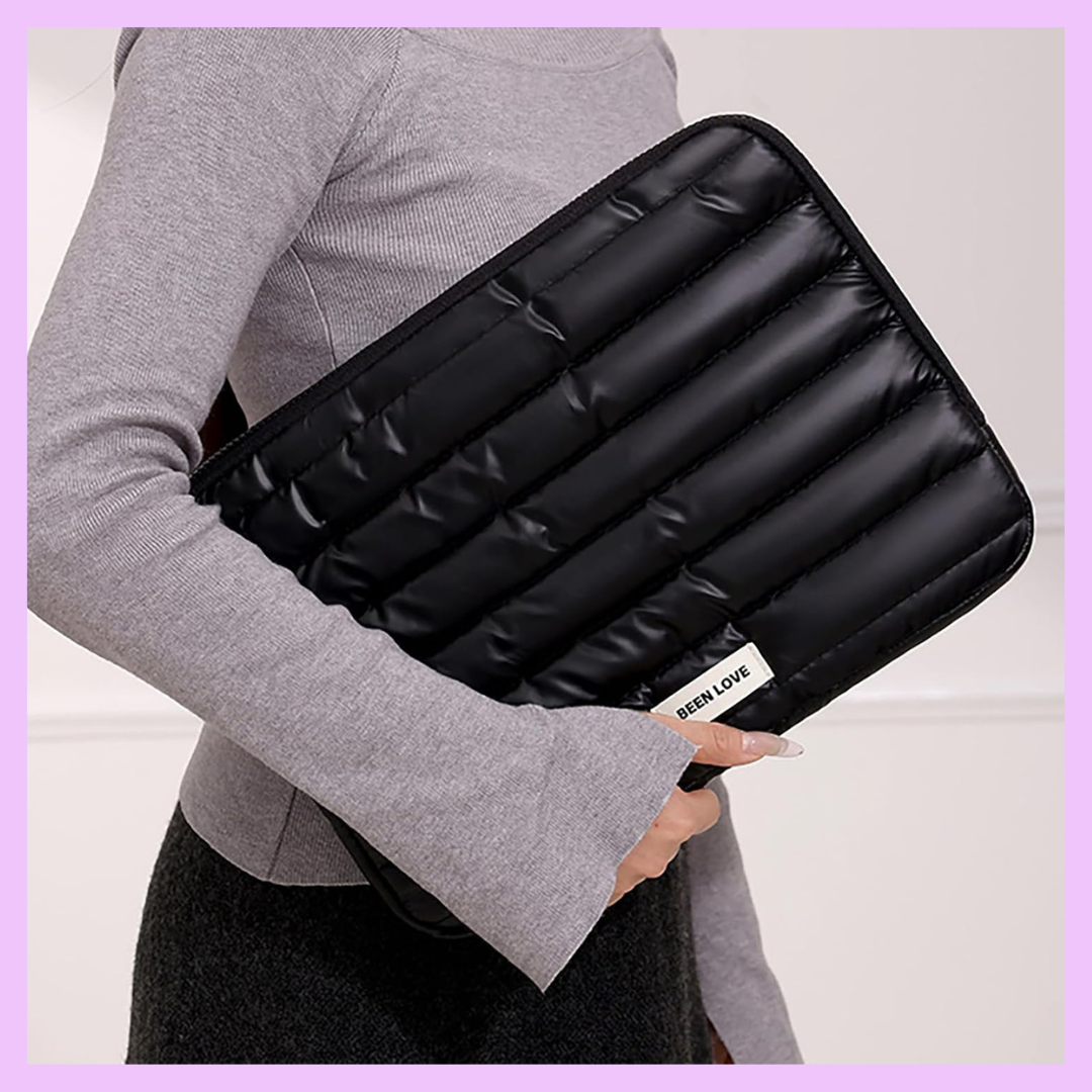 Black quilted laptop sleeve carried by hand featuring lightweight portable design and premium protection